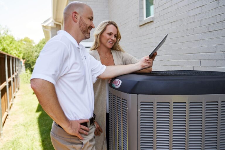 A happy couple reading energy-saving tips for their HVAC system